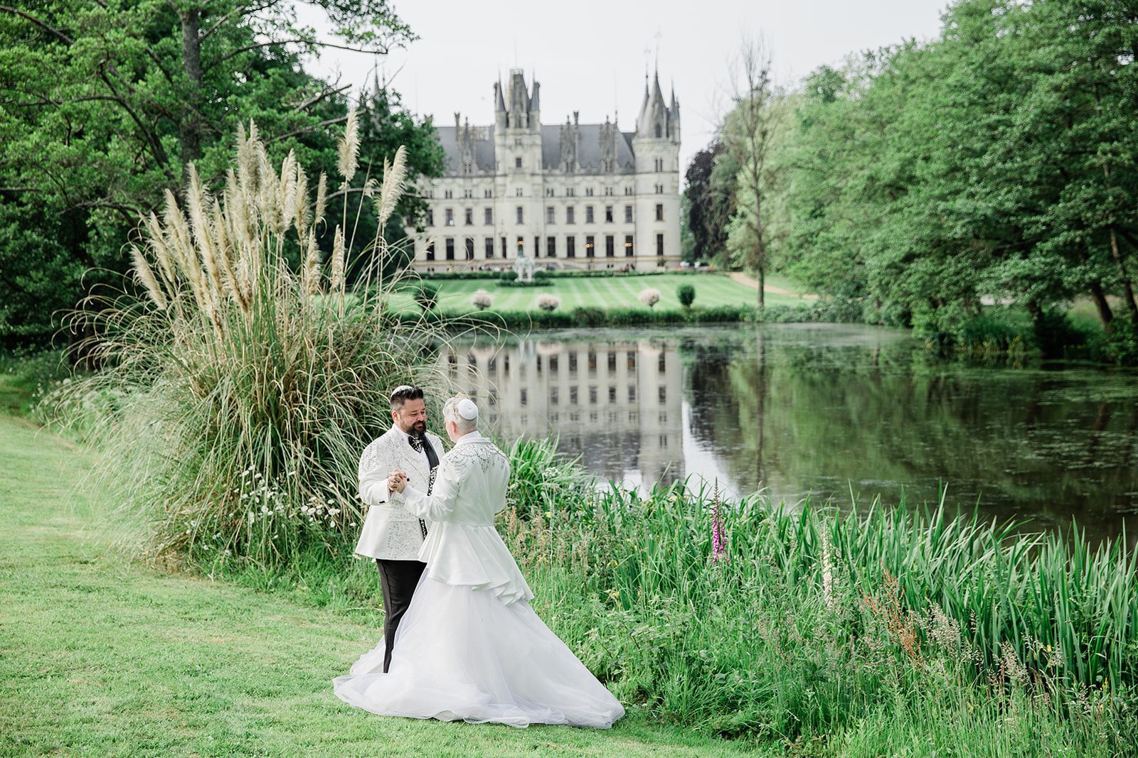 romantic gay couple by lake at chateau challain